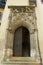 Medieval gothic style building entrance door with stone carved decoration in Regensburg, Germany.