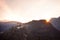 Medieval Hohenwerfen Castle towering over the Austrian town of Werfen at sunset turns pink-orange. Guard castle before the