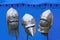 Medieval knight helmets on blue tent background.