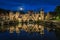 Medieval Koppelpoort city gate with the reflection in the river at night