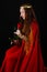 Medieval lady in red. A beautiful queen in a red cloak