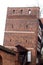 Medieval leaning defence tower of Torun over white sky