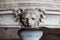 Medieval lions head carved out of stone at base of large stone bowl in Castle at Carcassonne, France