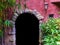 Medieval looking arch doorway with a lantern, castle architecture, dark door opening in a wall