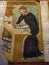 A Medieval monk copies a manuscript in an ancient fresco