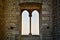 Medieval mullioned window with countryside at the horizon