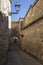 Medieval neighborhood in Baeza, alleyway with stone arch, Jaen p