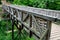 Medieval oak wood, bolted. Bridge over the moat. the railing is made of massive beams, between which several thin oak rods are wov