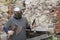 Medieval old knight helmet and chain mail for protection in battle. Very heavy headdress on stand in nature. Middle ages armor con