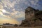 Medieval Ouranoupoli Tower with pilgrims ferry boat, Chalkidiki, Greece