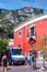 Medieval Positano cityscape on rocky landscape, buses with people and tourists coming to the cozy streets full of local businesses