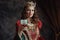 medieval queen in red dress with goblet and crown