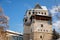 Medieval renaissance water castle with half-timbered tower with snow in winter sunny day, Historic Romantic chateau Blatna near