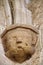 Medieval sculpture of head supporting column in church