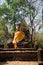 Medieval sculpture of a seated Buddha on the ruins of an ancient Buddhist temple Wat Khao Suwan Khiri