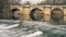 Medieval stone bridge, puente mayor, crossing rio carrion in winter, palencia, spain