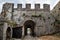 Medieval stone wall with tunnel and gate of Rozafa castle in Shkodra Albania. Ancient antique landscape with a dilapidated