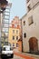 Medieval street in old Riga, Latvia. View of Saint John Church red bulding andold industrial building left, Riga