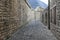 Medieval street with wall made of rocks and pebbles in the villa