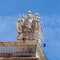 Medieval-themed sculptures on top of historic building in Lisbon, Portugal