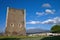 Medieval tower with mount Etna in background