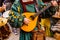 Medieval troubadour playing an antique guitar