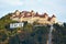 Medieval walled city Rasnov on hill, Romania. Autumn landscape with Medieval fortification Castle Rasnov