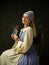 Medieval Woman in Historical Costume Wearing Corset Dress and Bonnet.