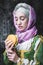 Medieval woman holding a burger.anachronism