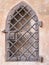 Medieval wrought iron fence door in a sand stone wall