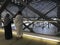 MEDINA, SAUDI ARABIA - MAY 27, 2019 :  A Muslim couple overlooks  bullet trains on tracks at HSR Madinah station in Medina, Saudi