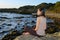 Meditating colored girl on sea shore