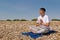 Meditating on a stony beach