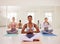 Meditating, yoga class or zen friends sitting together in relaxing, healthy or calm pilates studio. Diverse group of