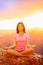 Meditating yoga woman at sunset in Grand Canyon