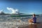 Meditating young man faces big wave