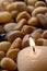 Meditation Candle Burning on Brown Pebbles