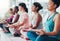 Meditation exercise, yoga class and healthy women together for fitness, peace and wellness. Diversity group in lotus at