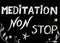 Meditation non stop sign, message written with chalk on blackboard