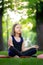 Meditation in the park in the lotus position little girl meditates and relaxes