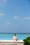 Meditation. Photo of a woman who is sitting in the lotus position on the ocean coast. Maldives