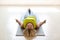 Meditation and pilates practice. Caucasian woman lying on the floor in shavasana with her feet up on a small ball in the