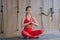 Meditation pose in yoga class. Girl opens her eyes, makes hands praying namaste.