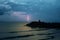 Meditation on the rocks, a man sitting on a rock in the sea at sunset