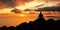 Meditation on the rocks, a man sitting on a rock in the sea at sunset