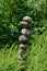 Meditation space in peaceful garden with river rock stack, serene green foliage