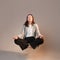 Meditation and stress control at work, a young woman in a business suit,