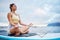 Meditation, surf and sea with a woman on a surfboard floating out in nature with a cloudscape and mockup. Yoga, ocean