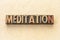 Meditation word abstract in wood type