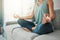 Meditation, yoga peace and hands of woman working on spiritual wellness on living room sofa in her house. Calm person